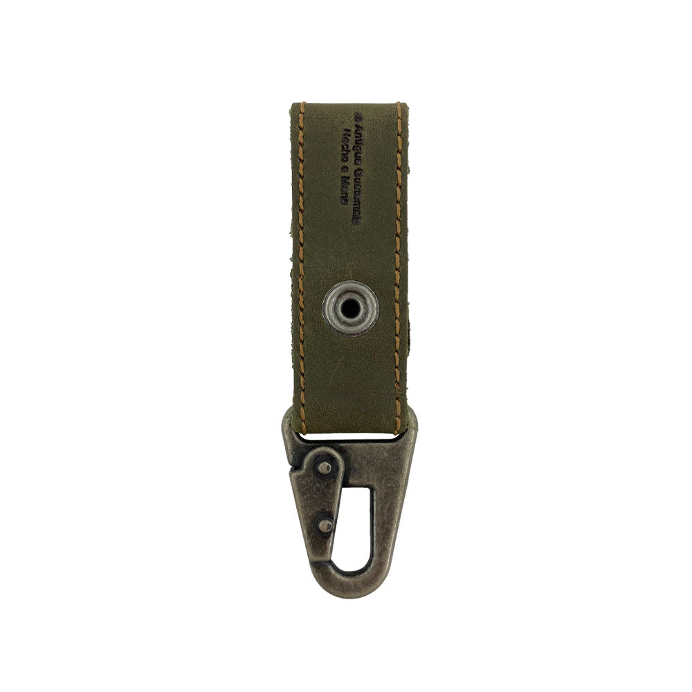 Hide & Drink Key Ring Holder with unique olive green leather backing and metal clip. This handcrafted piece, made from Full Grain Leather, reflects the artisanship from La Antigua Guatemala & Oaxaca Mexico, highlighting Small Batch Production and Fire Branded details.