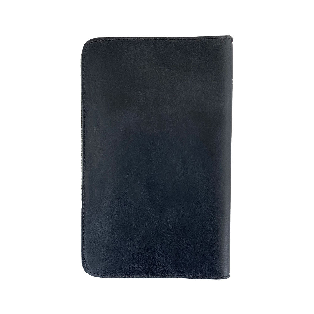 Back view of a sleek black Journal Cover for Moleskine Cahier L (5 x 8.25 in.) by Hide & Drink. Crafted from full grain leather, this rustic protector fits large size (5 x 8.25 in.) notebooks and exemplifies artisan quality and small batch production.