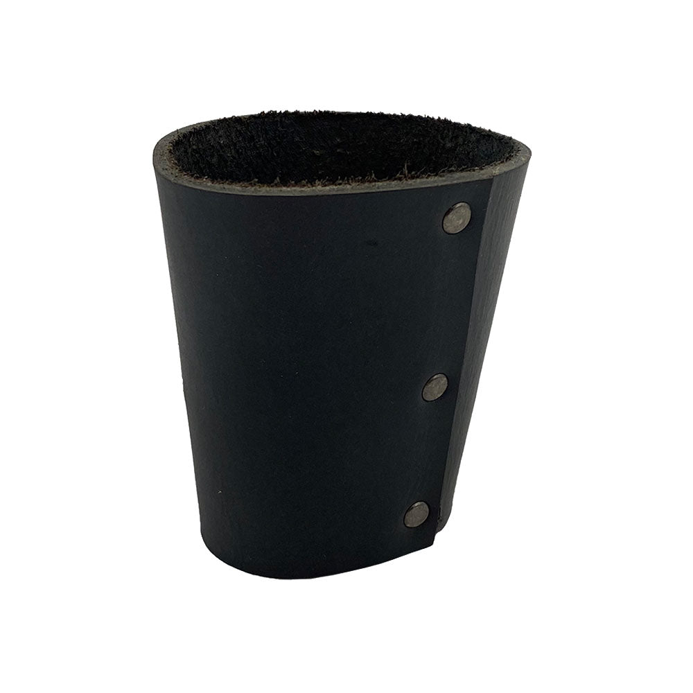 Close-up of the Hide & Drink black leather Pint Sleeve, highlighting its durable construction with stylish brass metal rivets. This handmade product is perfect for temperature control and makes for an excellent gift, embodying small batch production quality from La Antigua Guatemala & Oaxaca Mexico.