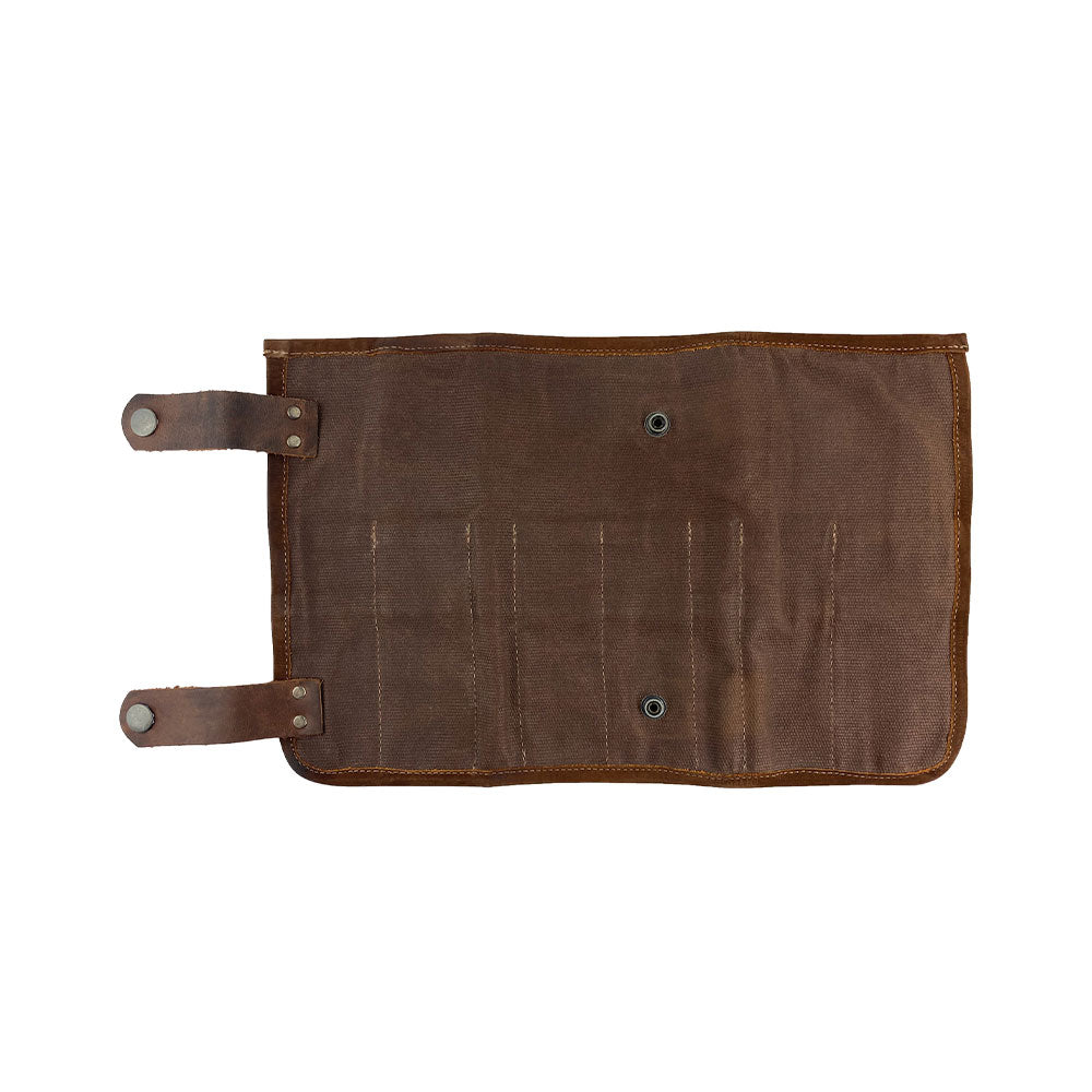 Close-up view of Hide & Drink's Barber Tool Roll, featuring a Snap Tool Roll Up Bag with 14 Slots ideal for your scissors & screwdrivers. Made from Full Grain Leather, this portable carry case embodies StockyardX's small batch production ethos, handcrafted, hand cut, hand sewn, and fire branded in La Antigua Guatemala & Oaxaca Mexico.