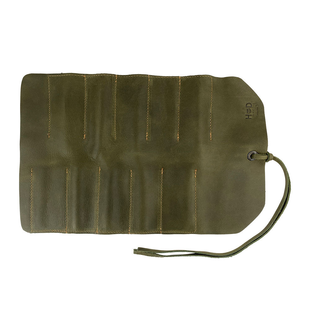 Hide & Drink Tool Roll features an elegant small tool roll-up bag with 10 slots, designed in fine full grain leather. Perfect as a portable carry-on pouch for woodworking tools, it enhances workshop storage capabilities. Each handmade item is produced in La Antigua Guatemala & Oaxaca Mexico, emphasizing artisan craftsmanship.