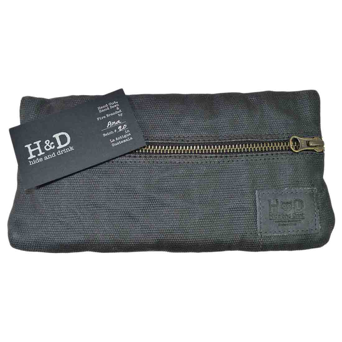 Brand detail of the black Hide & Drink Vape Pen Case (Accessories not included), emphasizing its artisanal quality. A superior Pen Accessories Kit Pouch Holder ensuring secure fit. G Pen Soft Travel Bag Handmade from Waxed Canvas, Full Grain Leather, StockyardX, Small Batch Production, Hand Cut, Hand Sewn, Fire Branded, Artisan, Handmade in La Antigua Guatemala & Oaxaca Mexico.