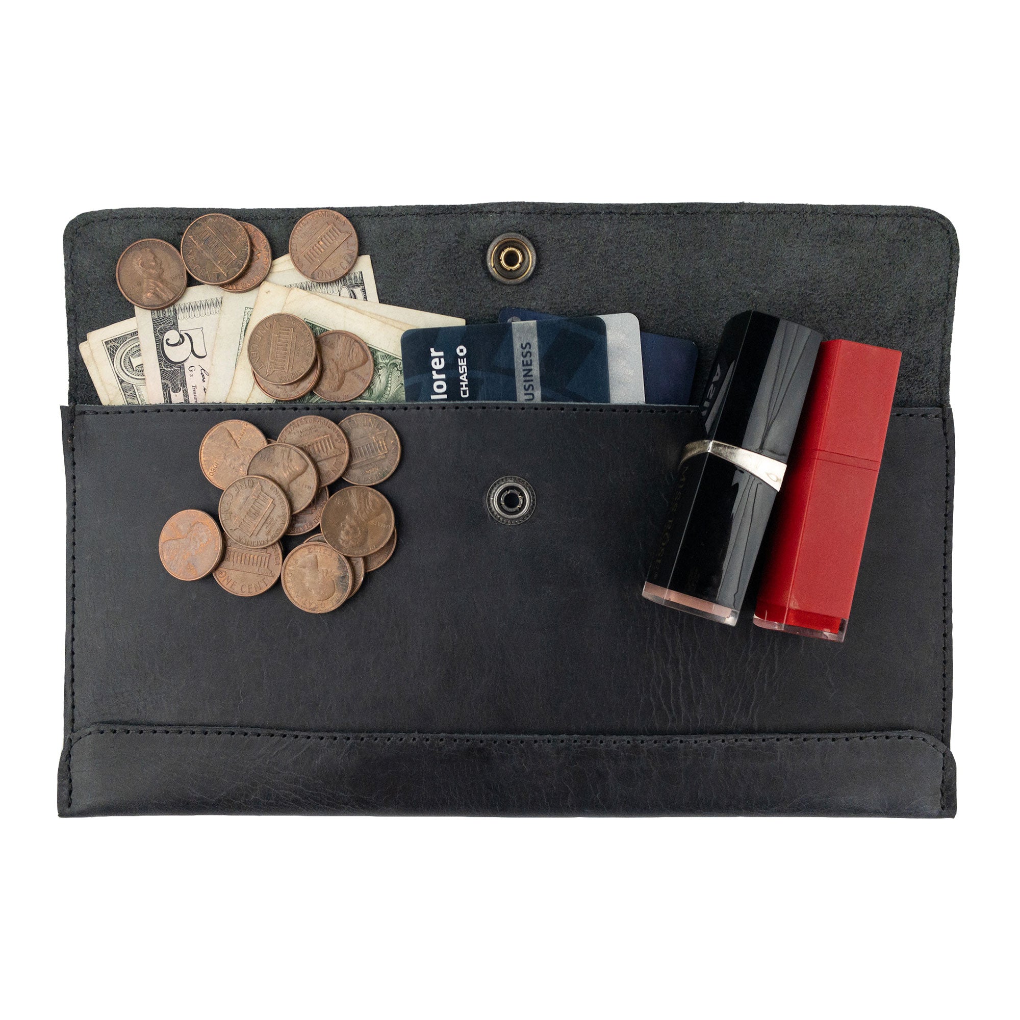 Hide & Drink's Travel Hand Wallet filled with coins and cosmetics, demonstrating practicality and style in Full Grain Leather. This Travel Wallet is an artisan creation, made through Small Batch Production in La Antigua Guatemala & Oaxaca Mexico.
