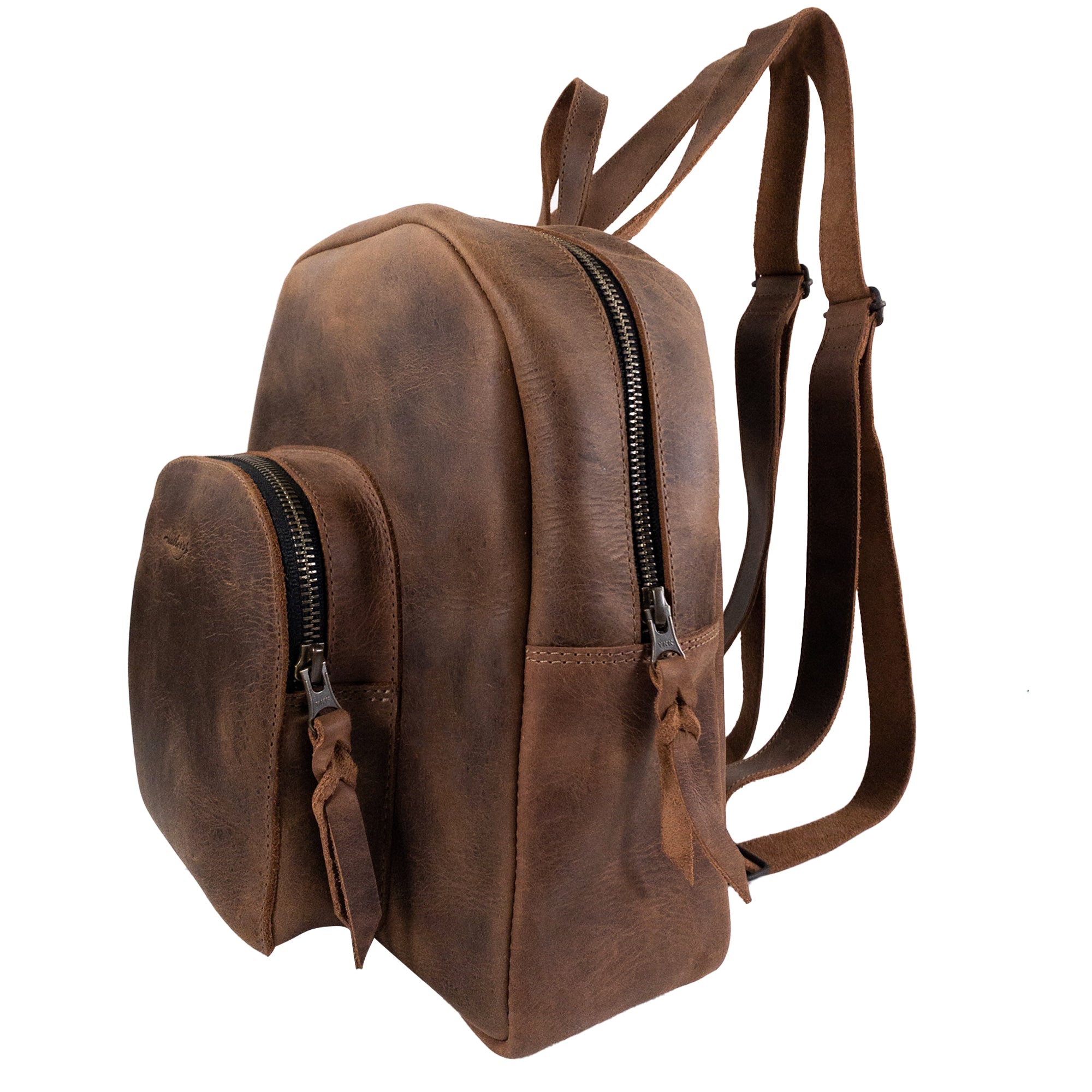 Side view of Heather's Minimalist Backpack, highlighting its craftsmanship from full grain leather. This functional backpack features adjustable straps and space for organizing notebooks and makeup, making it a must-have for travel. Each bag is handmade in La Antigua Guatemala with an emphasis on artisanal quality and small batch production.