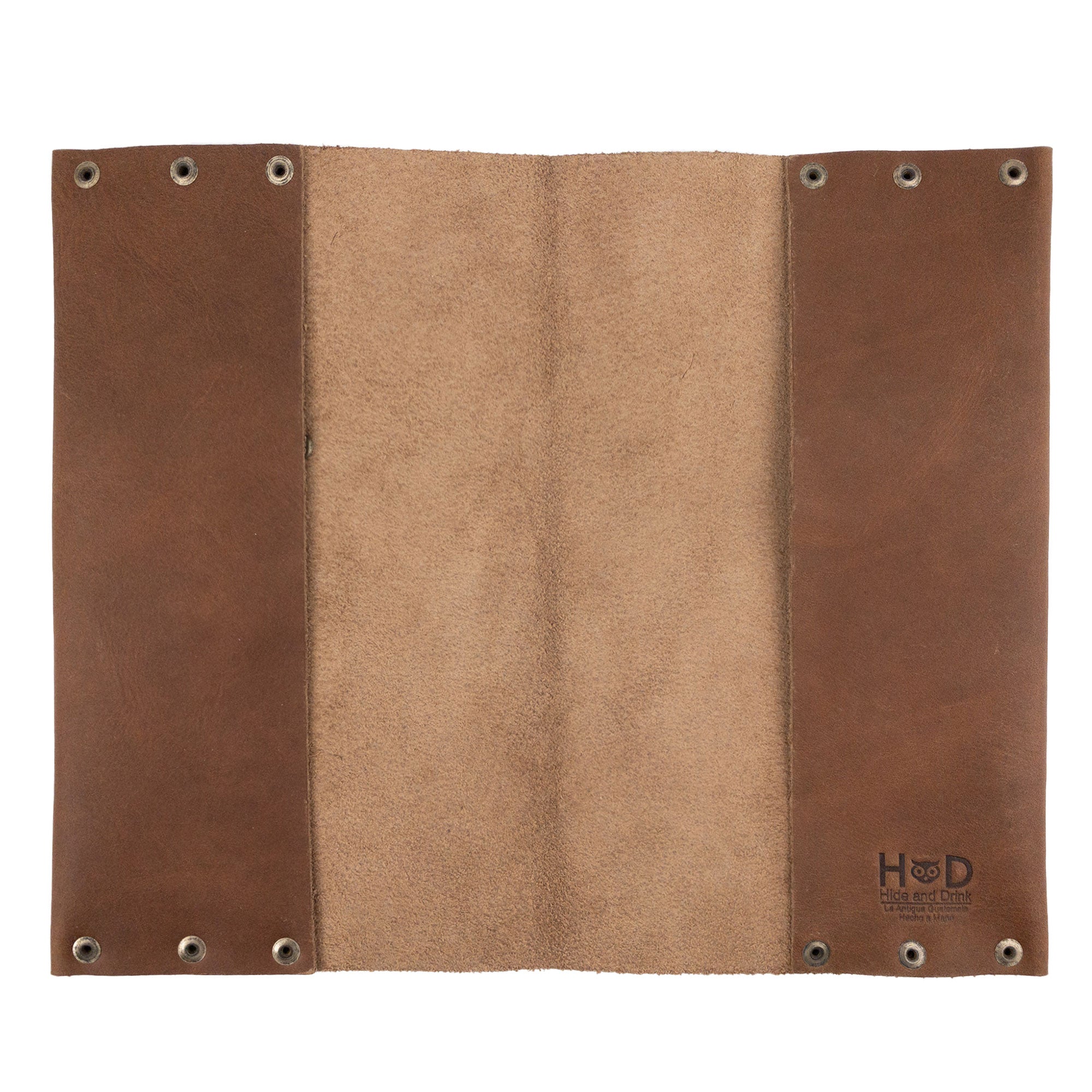 Open view of the Riveted Journal Cover (5 x 8.50 in.) from Hide & Drink, highlighting its smooth interior. Made from full grain leather, this vintage style journal cover is hand cut and sewn by artisans in La Antigua Guatemala & Oaxaca Mexico, ideal for showcasing your note-taking.