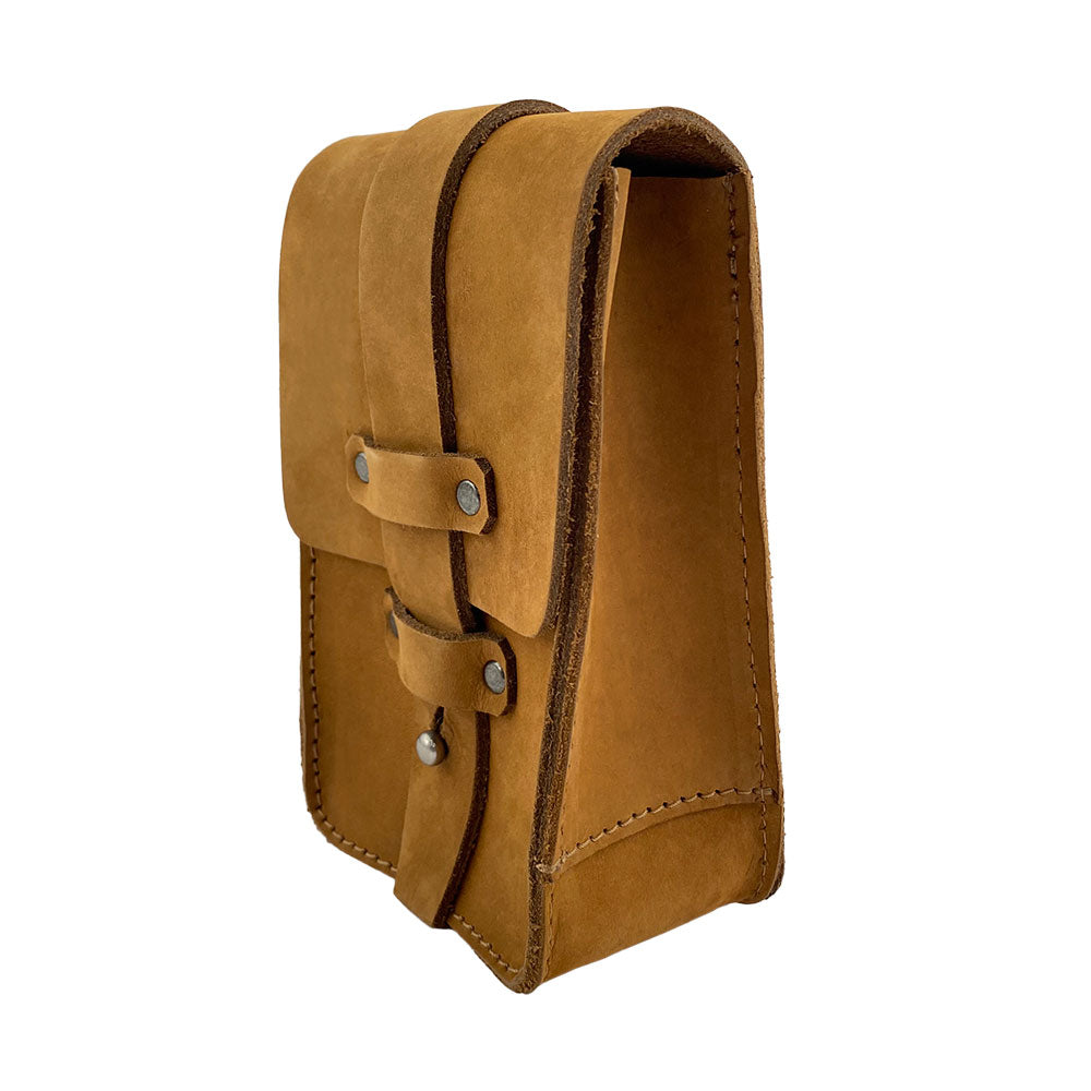 Side view of the tan Bartender Fanny Pack by Hide & Drink, made from thick full grain leather. Ideal for holding bartending tools like a Bartender Bottle Opener, this stylish and durable fanny pack is handcrafted in La Antigua Guatemala.