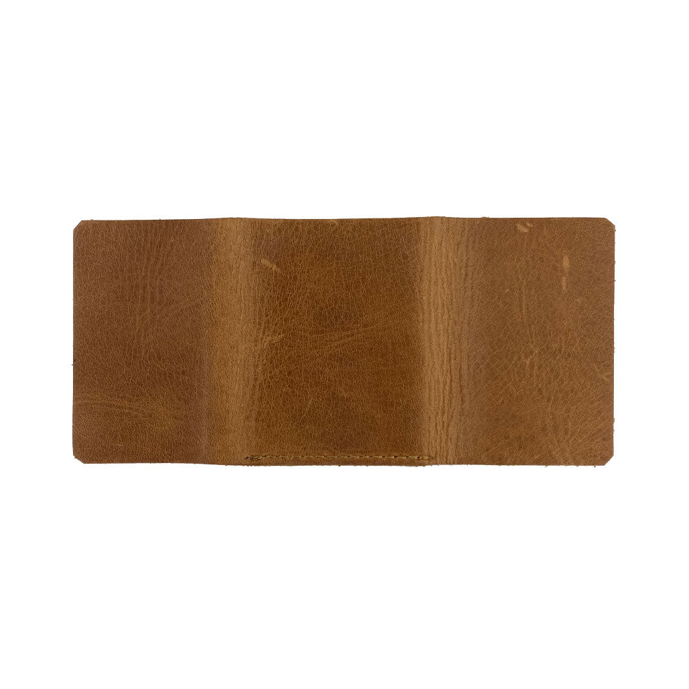 A close-up view of the Hide & Drink Minimalist Wallet Bills Only that demonstrates its quality Full Grain Leather. This Ultra Minimalist Wallet is your go-to cash organizer, designed with hand cut precision and the artisan excellence synonymous with Hide & Drink.