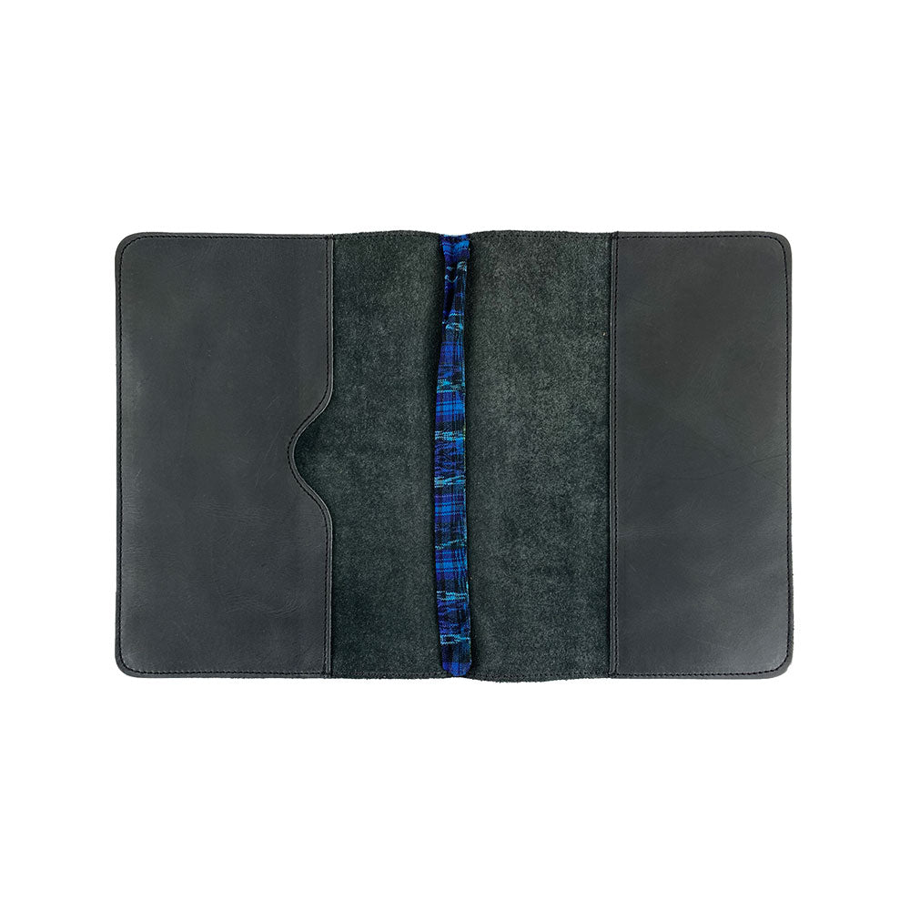 Open view of the interior of the black Full Grain Leather Journal Cover for Moleskine Cahier XL (7.5 x 9.75 in.) by Hide & Drink, featuring beautifully woven bookmark. This meticulous design supports your journaling pursuits while highlighting small batch production values from Mexico.