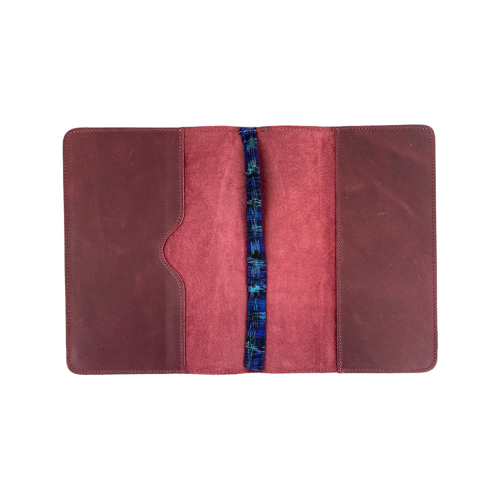 Interior view of the brown leather Full Grain Leather Journal Cover for Moleskine Cahier XL (7.5 x 9.75 in.) by Hide & Drink, featuring open pages and a pen. This notebook case celebrates the artistry of small batch production from Guatemala.