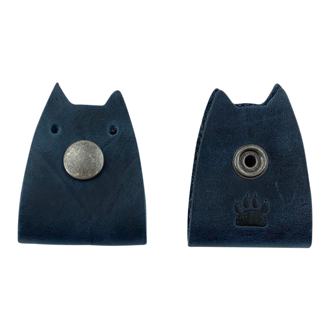 Displaying Taco Dog's Navy Cat Cord Keeper (2 Pack) with a paw print design. Perfect for organizing headphones, chargers, and earbuds. Crafted with artisanal quality in La Antigua Guatemala & Oaxaca Mexico.