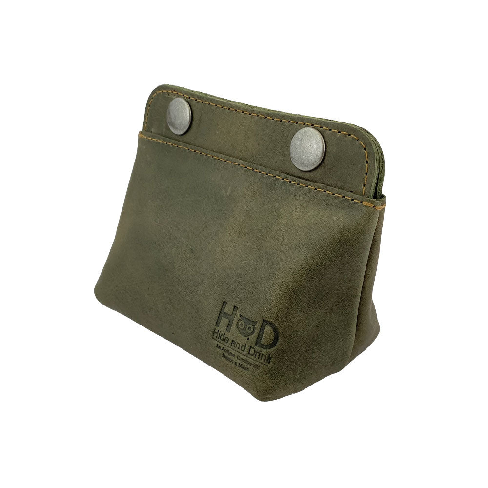 Side angle of the Hide & Drink Double Snap Pouch, showcasing its use as a coin purse and cash holder. This high-quality full grain leather pouch is artisan-crafted in La Antigua Guatemala.