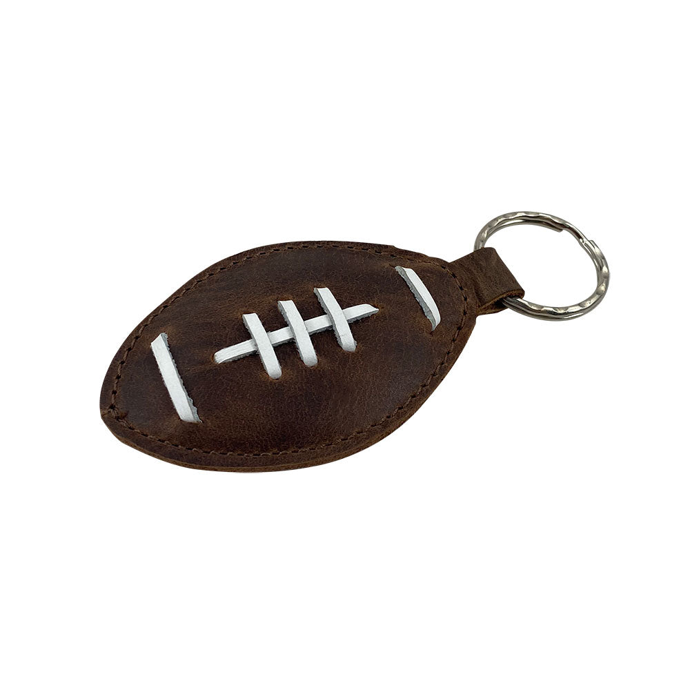 Close-up of the Football Key Chain by Hide & Drink, depicting intricate stitching and Full Grain Leather design. An ideal accessory for football lovers, featuring tags Football Keychain, Small Batch Production, Hand Cut, Hand Sewn, Fire Branded, Artisan, Handmade in La Antigua Guatemala & Oaxaca Mexico.