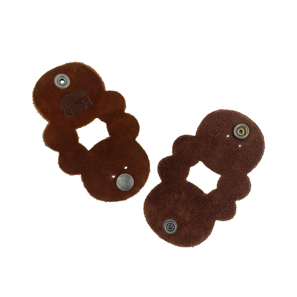 Two Bear Shaped Cord Keepers (Cord Clam) by Hide & Drink, designed with Full Grain Leather, showcasing a fun shape and functional design for cord organization. Handmade in La Antigua Guatemala & Oaxaca Mexico, emphasizing artisan quality and small batch production.