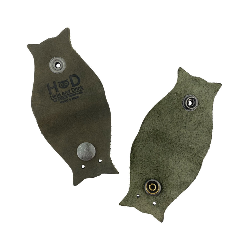 Functional Owl Shaped Cord Keeper (2-Pack) by Hide & Drink highlighting its practical use with the brand logo beautifully embossed. Owl Shaped Cord Keeper (Cord Clam) 2-Pack. Full Grain Leather, StockyardX, Small Batch Production, Hand Cut, Hand Sewn, Fire Branded, Artisan, Handmade in La Antigua Guatemala & Oaxaca Mexico.