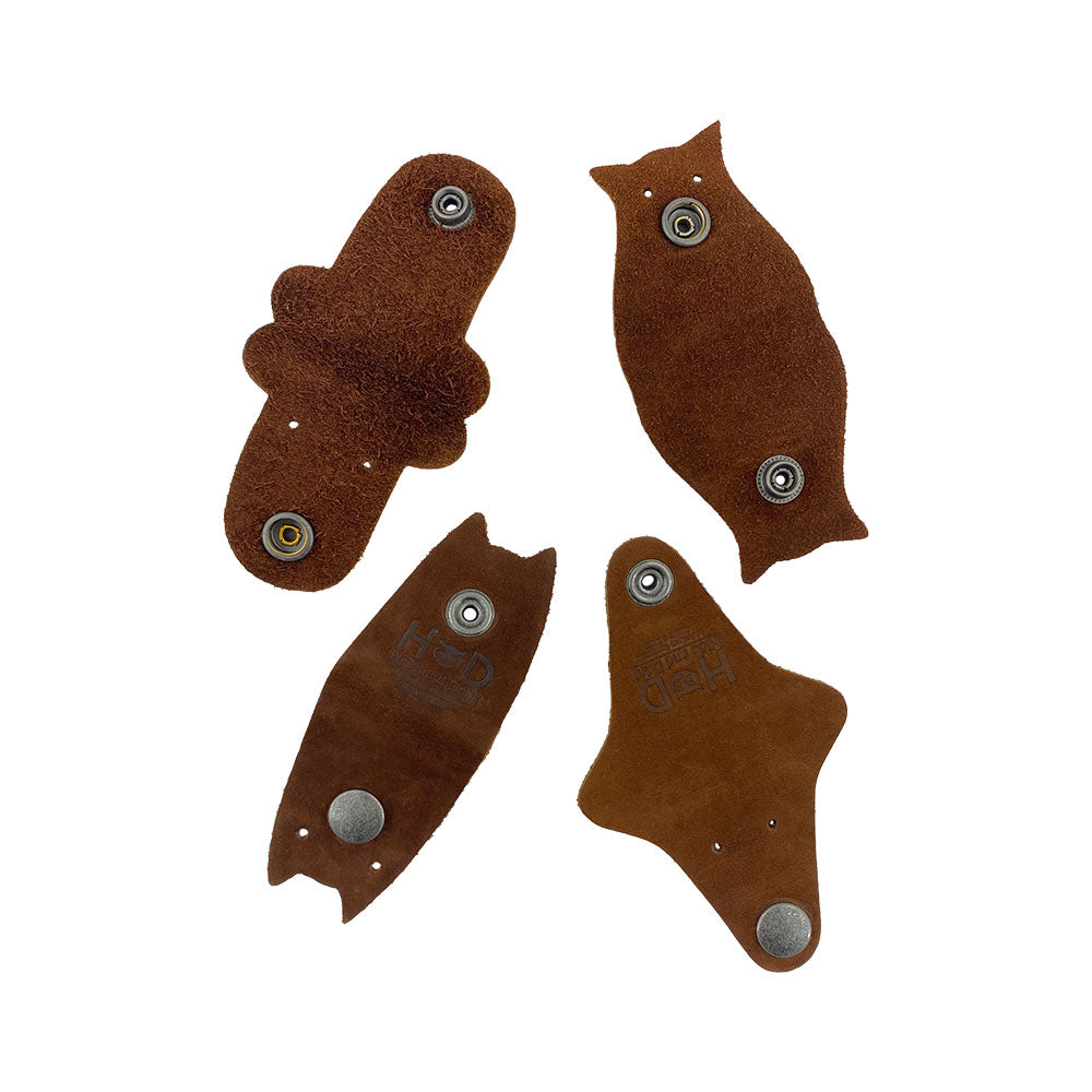 Furry Friends Cord Keeper (4-Pack) with charming animal shapes, designed from premium Full Grain Leather by Hide & Drink for neat cable storage. Furry Friends 4-Pack Cord Keeper (Cord Clam), Full Grain Leather, StockyardX, Small Batch Production, Hand Cut, Hand Sewn, Fire Branded, Artisan, Handmade in La Antigua Guatemala & Oaxaca Mexico.