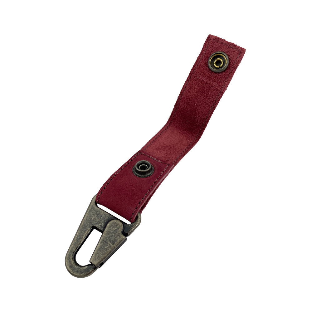 Side angle of the red suede leather Key Ring Holder from Hide & Drink, illustrating its practical design and comfortable grip. Key Ring Holder, Full Grain Leather, StockyardX, Small Batch Production, Hand Cut, Hand Sewn, Fire Branded, Artisan, Handmade in La Antigua Guatemala & Oaxaca Mexico.