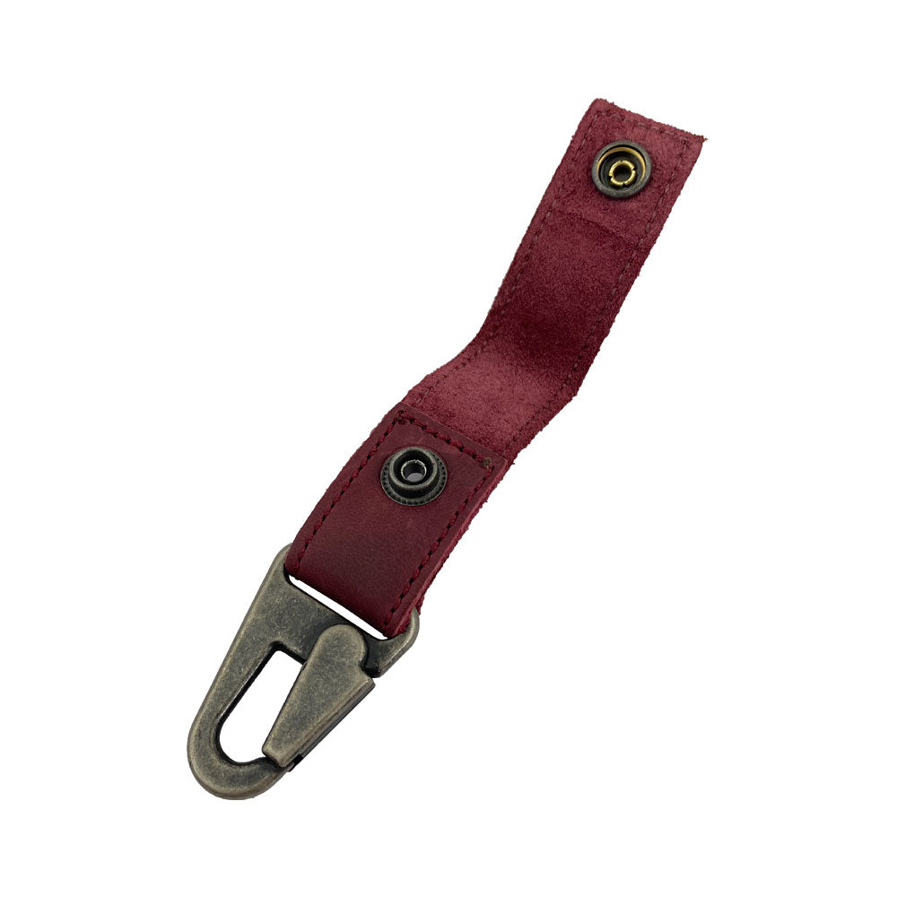 Side angle of the red leather Key Ring Holder by Hide & Drink, showcasing its slim design and artisanal quality, perfect for daily use. Key Ring Holder, Full Grain Leather, StockyardX, Small Batch Production, Hand Cut, Hand Sewn, Fire Branded, Artisan, Handmade in La Antigua Guatemala & Oaxaca Mexico.