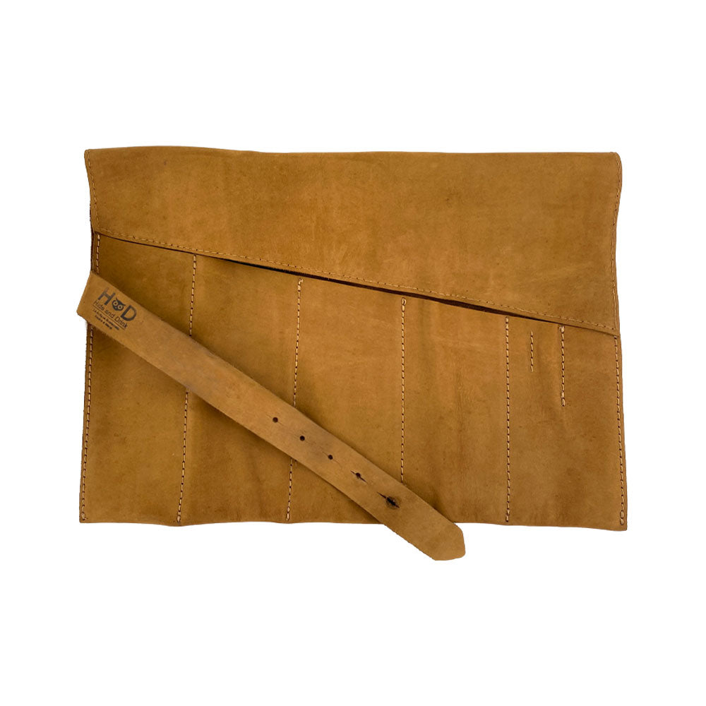 A detailed Large Tool Roll from Hide & Drink, featuring 6 slots for tools. This Portable Carry-On Pouch is essential for woodworking tools organization. Made with waxed canvas and full grain leather variations, this artisan product exemplifies hand-cut, hand-sewn craftsmanship from StockyardX, proudly made in La Antigua Guatemala & Oaxaca Mexico.