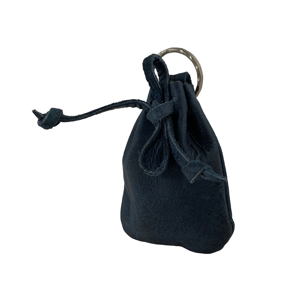 Side view of a Mini Medieval Pouch Keychain by Hide & Drink, featuring its unique design. This tiny bag with keyring is crafted from full grain leather, making it an excellent coin pouch while celebrating artisan work and small batch production from La Antigua Guatemala.