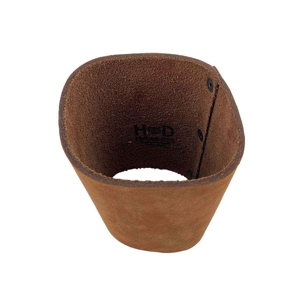 Inside view of the Hide & Drink brown leather Pint Sleeve emphasizing the fine craftsmanship. Offering natural insulation for your drinks, this small batch artisan product is charmingly adorned with brass metal rivets and is handmade in La Antigua Guatemala & Oaxaca Mexico.