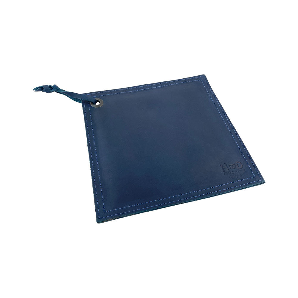 Side profile of the Hide & Drink Pot Pad, emphasizing its sleek design and handcrafted quality. This artisan hot pot pad is made for easy handling of cookware.
