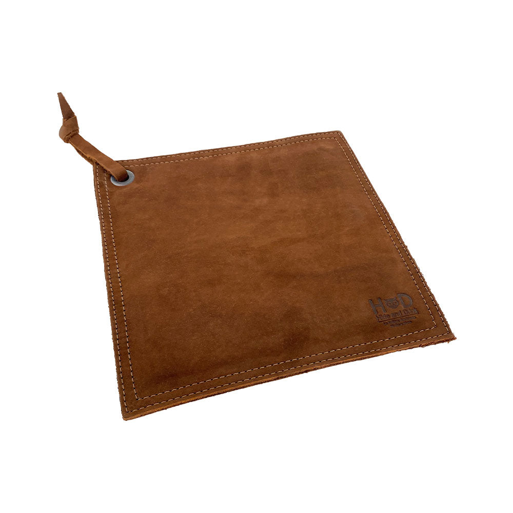Hide & Drink Pot Pad displayed for functionality with its diverse uses. This artisan crafted potholder features double layers and full grain leather, perfect for protecting surfaces from hot items. Handmade in La Antigua Guatemala & Oaxaca Mexico.
