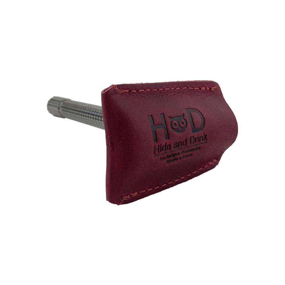 Hide & Drink's Razor Head Cover elegantly displays the protective sheath fitted onto a razor, showcasing its perfect fit and vibrant, artisan-crafted look. Ideal for any double edge safety razor, this shaving travel cover combines functionality with full grain leather design.