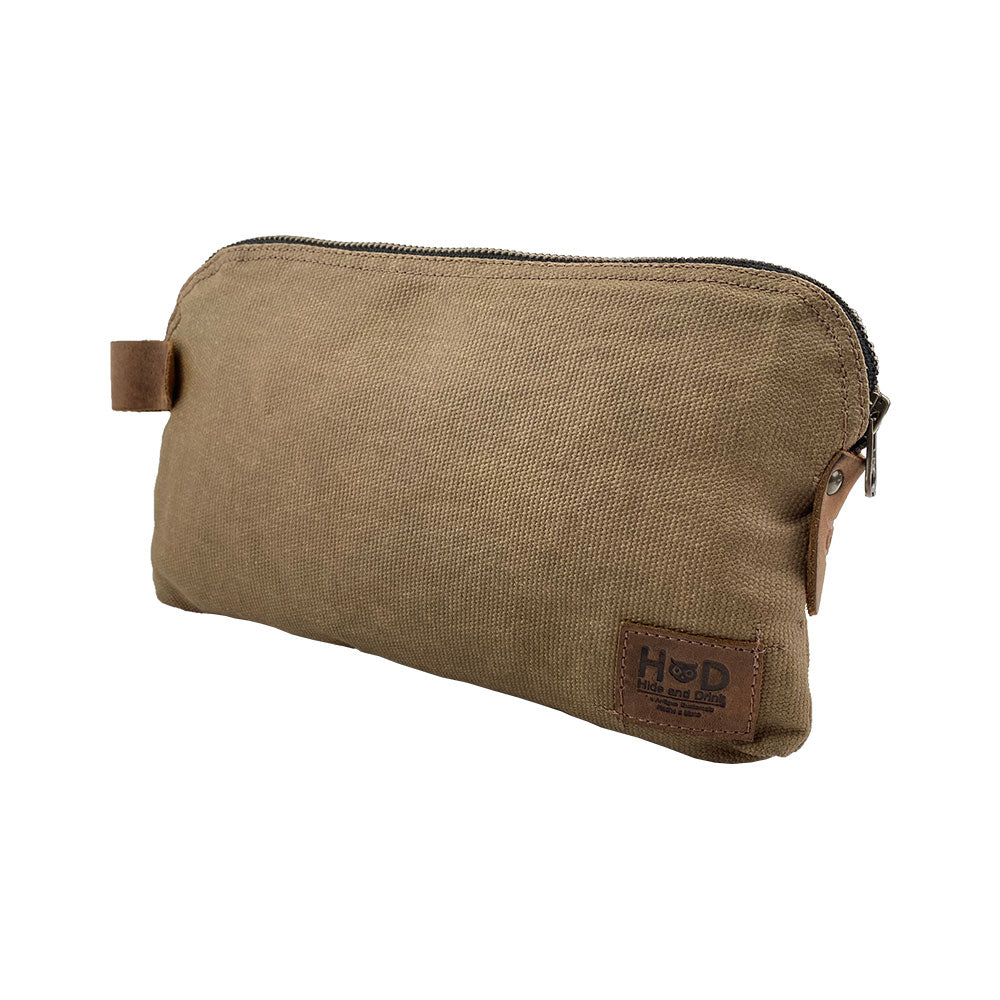 Dopp Kit Utility Bag by Hide & Drink showcasing its sophisticated side profile for practicality in travel. This large rustic all-purpose Dopp Kit Utility Bag is crafted from premium full grain leather with emphasis on artisan craftsmanship through hand cut and hand sewn quality, handmade in La Antigua Guatemala & Oaxaca Mexico.