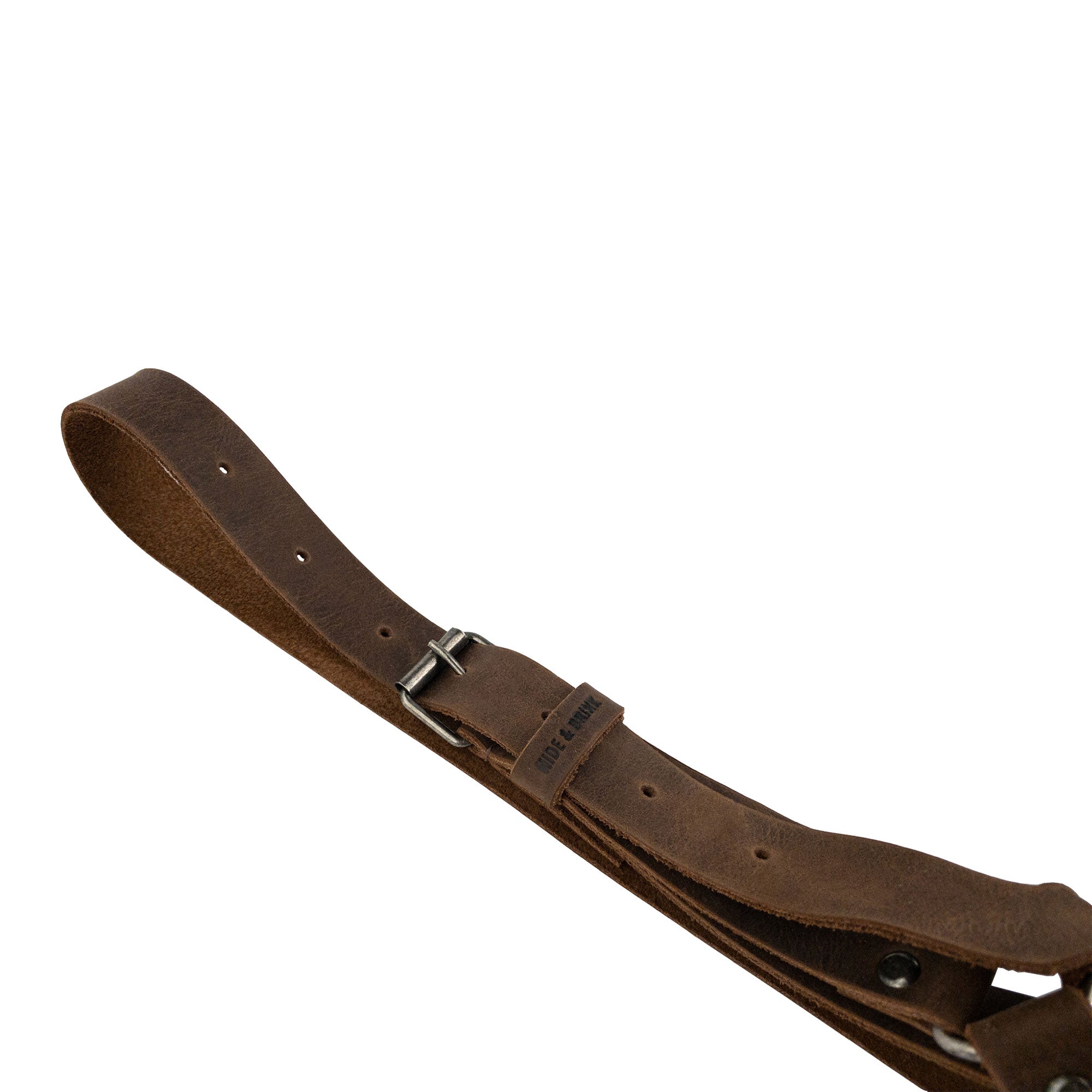 Close-up of the buckle on Hat Hanger by Hide & Drink, highlighting the adjustable strap design. This full grain leather accessory is perfect for car organization, embodying minimalist style while providing a durable solution for travel. Each item is artisan-made in La Antigua Guatemala & Oaxaca Mexico.
