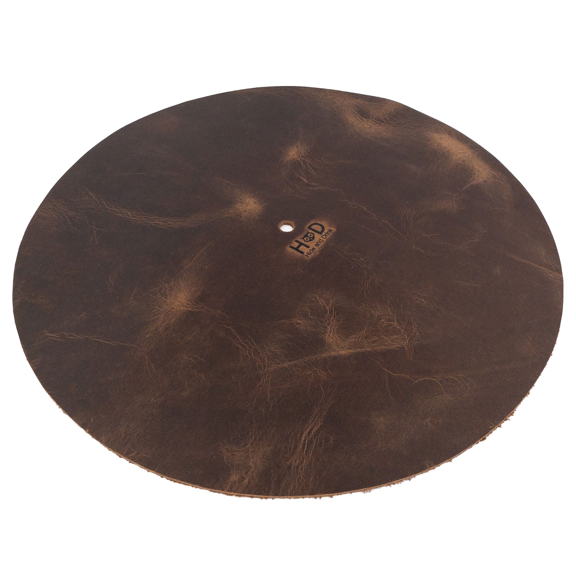 Hide & Drink Turntable Slipmat angled view showcasing its unique, rustic appearance made from durable full grain leather. This handmade artisan slipmat reduces static and enhances sound quality, fitting perfectly on your turntable and representing small batch craftsmanship from La Antigua Guatemala.