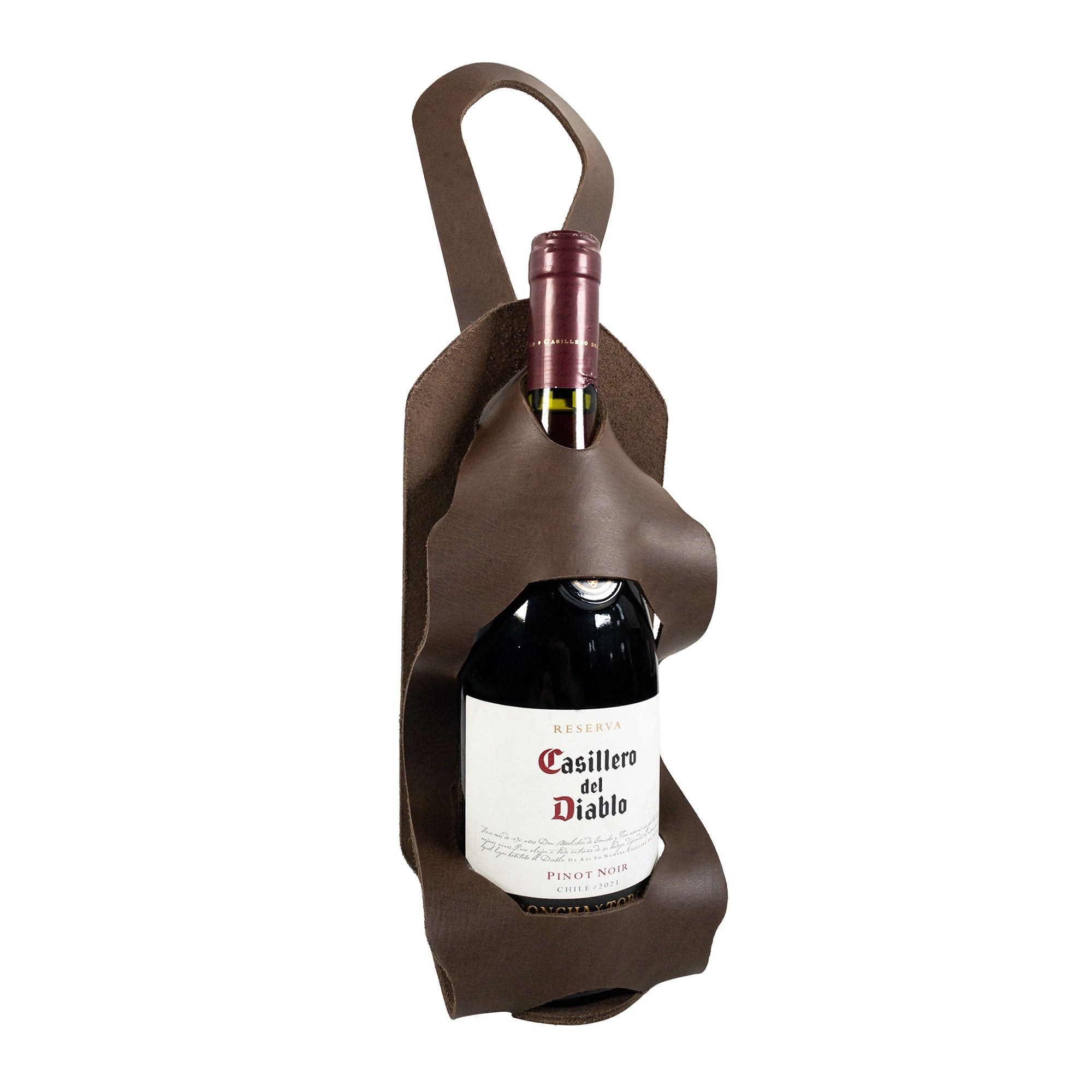 The Unibody Bike Wine Carrier by Hide & Drink elegantly showcasing a wine bottle. Made from high-quality Full Grain Leather, this handmade carrier is a result of skilled artisans' small batch production in La Antigua Guatemala & Oaxaca Mexico.