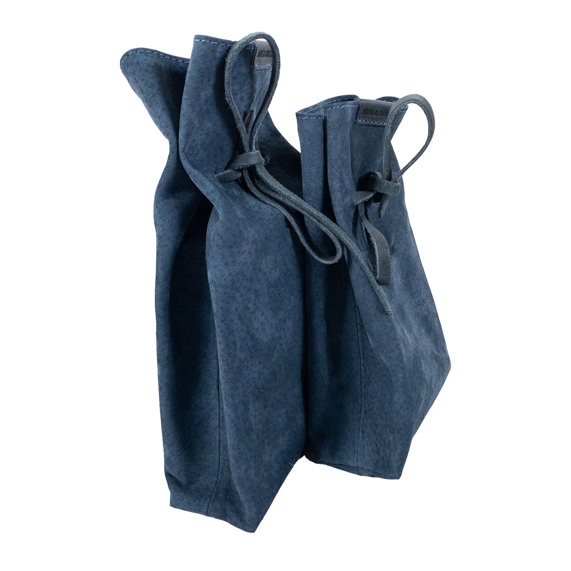 Showcasing Hide & Drink's Drawstring Sack (2 pack) filled with accessories, highlighting its usability in everyday life. Drawstring Sack (2 pack) Handmade from Sheepskin and Full Grain Leather, StockyardX, Small Batch Production, Hand Cut, Hand Sewn, Fire Branded, Artisan, Handmade in La Antigua Guatemala & Oaxaca Mexico.