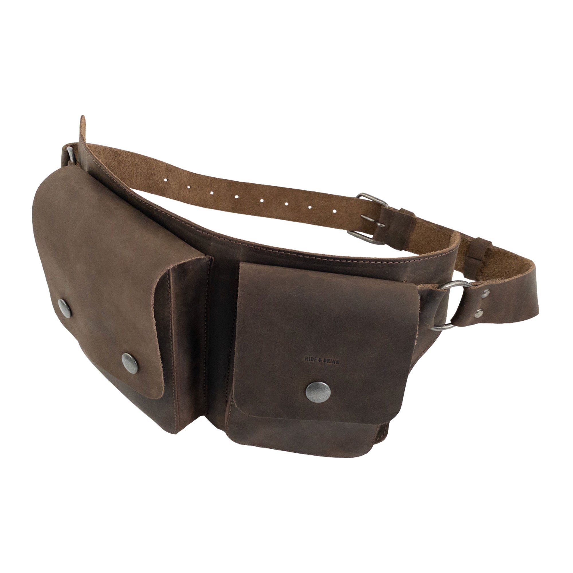 A side angle of the Hide & Drink Rectangular Waist Bag, demonstrating its dual pocket design in fine Full Grain Leather. This Waist Bag with Adjustable Belt is an essential outdoor accessory and tool holder for camping, featuring small batch production with hand-cut and hand-sewn details. Artisan quality handmade in La Antigua Guatemala & Oaxaca Mexico.