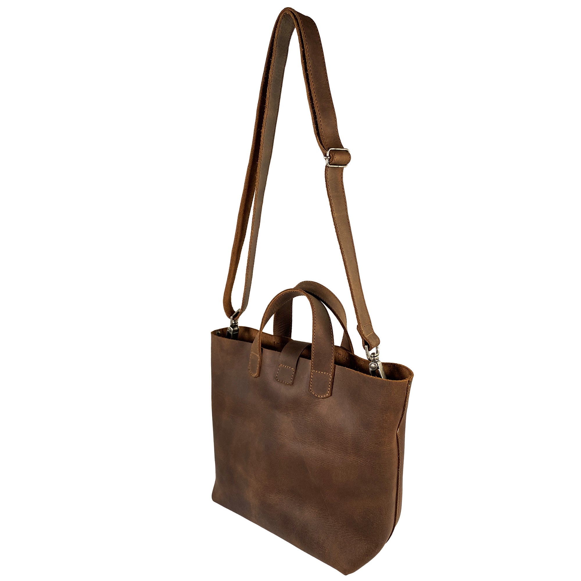 Heather's Crossbody Tote Bag with Pouch, highlighting the stylish back view of this rustic handbag, made from durable full grain leather. This vintage style shoulder case is suitable for everyday use, and supports artisan craftsmanship, handmade in La Antigua Guatemala & Oaxaca Mexico.