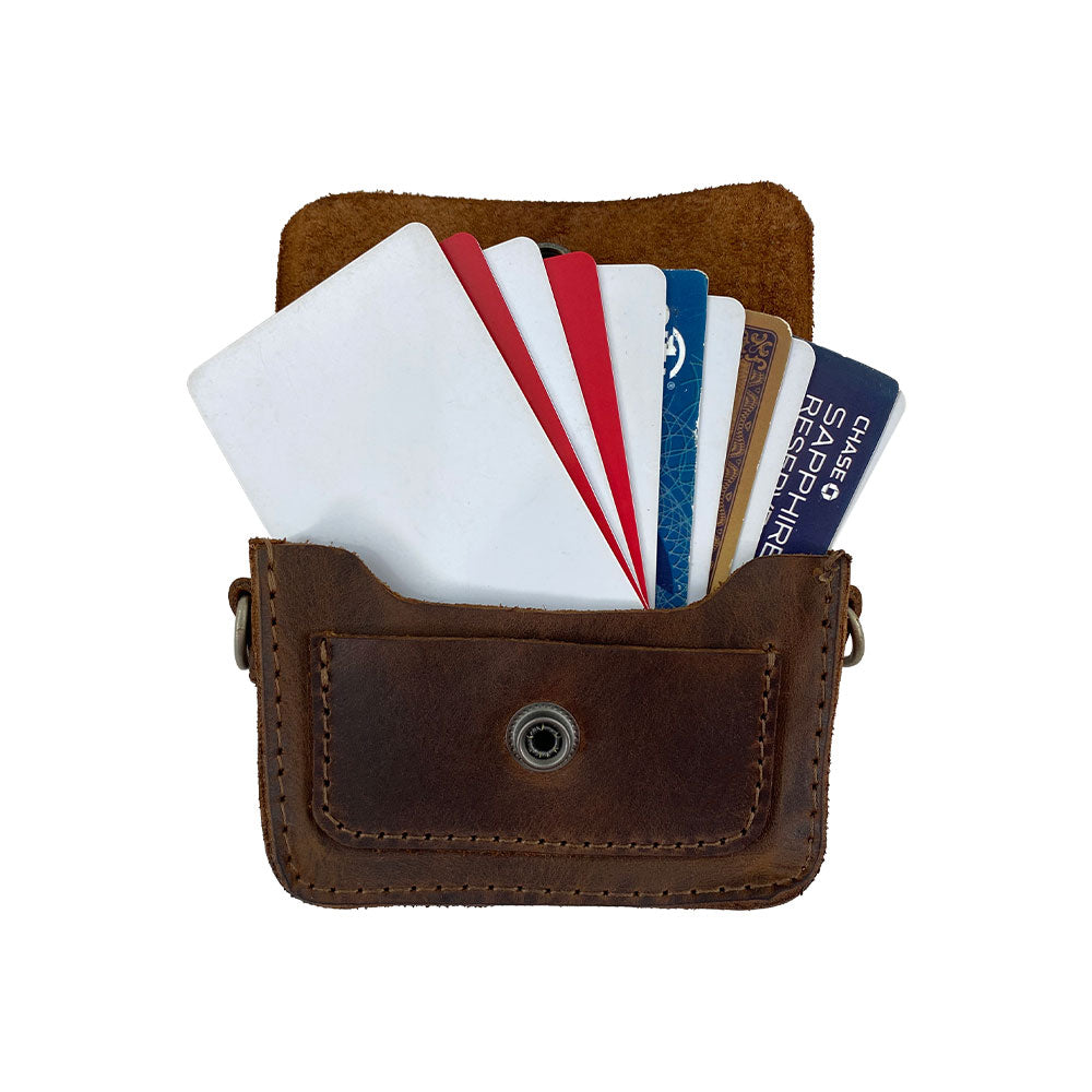 Hide & Drink's Card Holder Briefcase Style, highlighting the Mini Briefcase Card Holder filled with various cards. This Full Grain Leather case is designed to hold up to 10 cards and folded bills, emphasizing its function as an effective cash organizer crafted through artisanal methods.