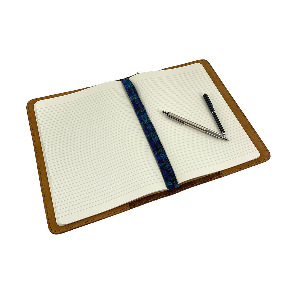 Front view of the vintage leather Full Grain Leather Journal Cover for Moleskine Cahier XL (7.5 x 9.75 in.) by Hide & Drink, presenting an elegant design. Perfect for creatives who appreciate handmade craftsmanship.