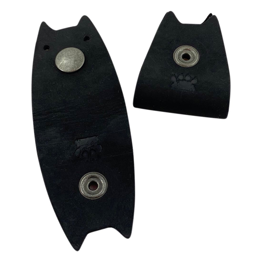 Black leather Taco Dog Cat Cord Keeper (2 Pack) displayed with cables neatly managed. This accessory helps keep your earbuds, headphones, and chargers organized. Snap together for travel convenience. Handmade in La Antigua Guatemala & Oaxaca Mexico with artisan care.
