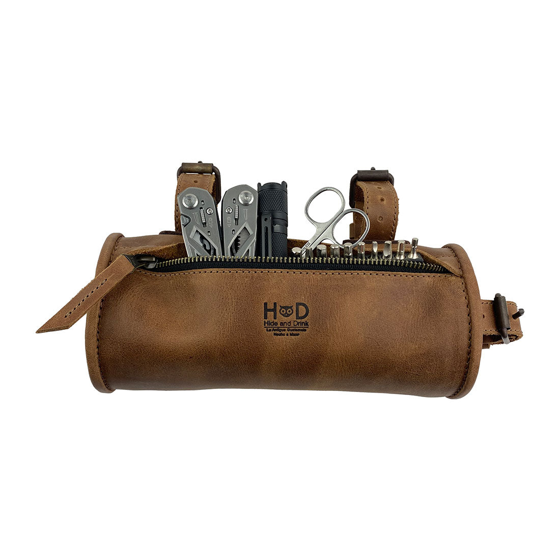Hide & Drink Bike Bag, a unique full grain leather cylinder tube pouch filled with essential tools. This stylish bicycle accessory combines functionality with artisan craftsmanship, featuring hand cut and hand sewn details, made in La Antigua Guatemala & Oaxaca Mexico.