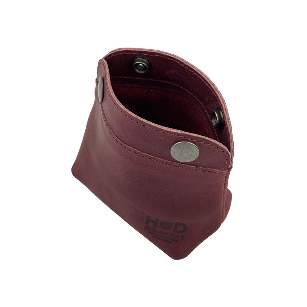 Interior shot of the Hide & Drink Double Snap Pouch demonstrating its utility as a cash & card holder and makeup organizer. This vibrant full grain leather item is handmade in La Antigua Guatemala.