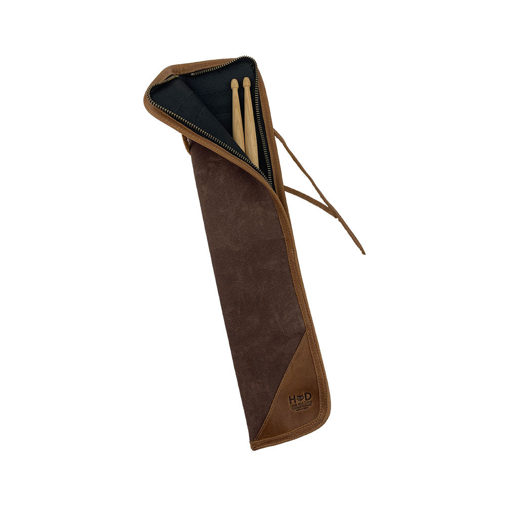 Open view of the brown Hide & Drink Drummstick Bag with drumsticks inside, combining functionality and style. Made from Waxed Canvas & Full Grain Leather, this Drumstick Bag Holder is essential for any drummer, demonstrating the commitment to hand crafted techniques in small batch production from La Antigua Guatemala & Oaxaca Mexico.