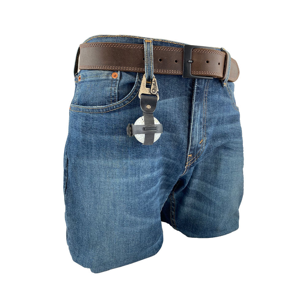 Modern Golf Ball Holder by Hide & Drink attached to jeans, featuring a practical belt loop hook and crafted from rustic full grain leather. This handmade item exemplifies small batch production, expertly crafted in La Antigua Guatemala & Oaxaca Mexico.