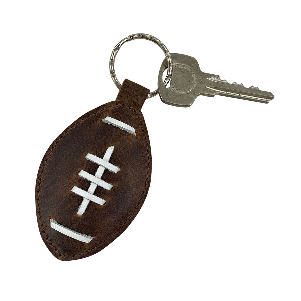 Another view of the Football Key Chain by Hide & Drink, showcasing its durable Full Grain Leather craftsmanship. Perfect for any sports fan, featuring tags Football Keychain, Small Batch Production, Hand Cut, Hand Sewn, Fire Branded, Artisan, Handmade in La Antigua Guatemala & Oaxaca Mexico.