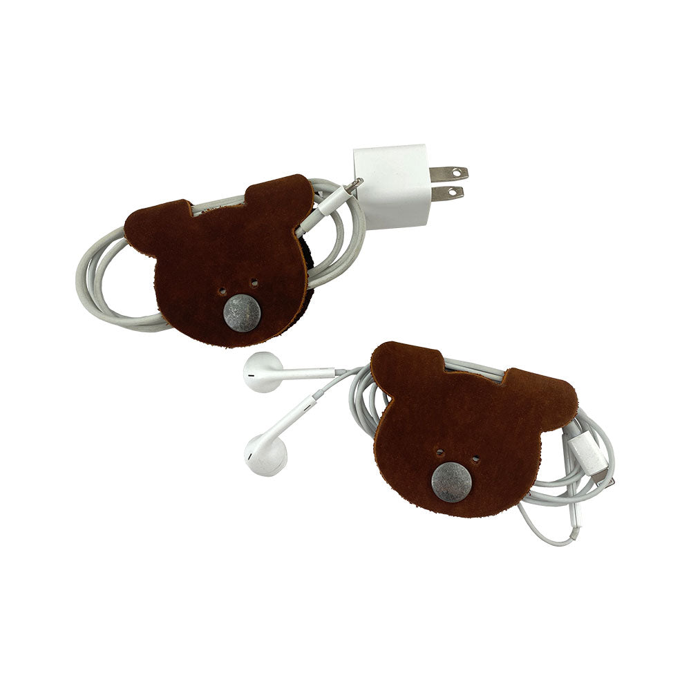 Bear Shaped Cord Keepers (Cord Clam) by Hide & Drink, used to organize charging cables, made of high-quality Full Grain Leather, fire branded and handmade, reflecting small batch production in La Antigua Guatemala & Oaxaca Mexico.