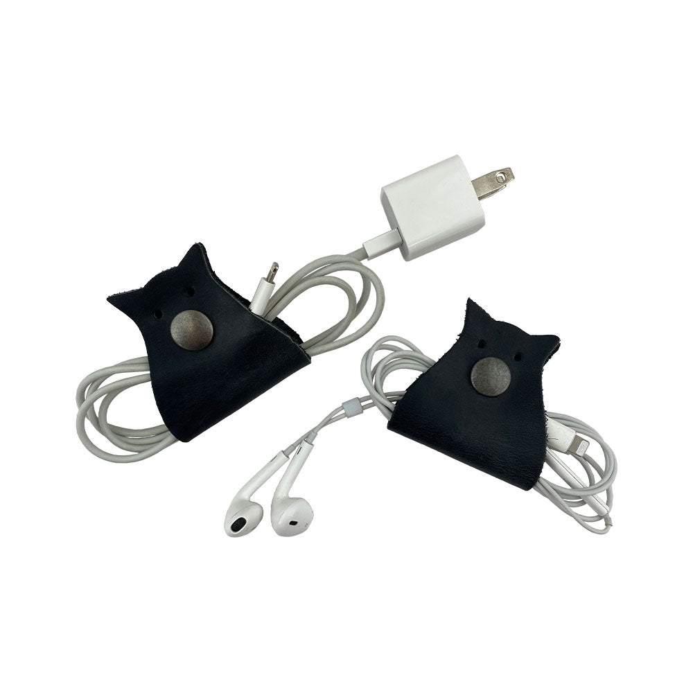 Elegant Owl Shaped Cord Keeper (2-Pack) by Hide & Drink featuring two black cord organizers ideal for tech lovers looking for style and functionality. Owl Shaped Cord Keeper (Cord Clam) 2-Pack. Full Grain Leather, StockyardX, Small Batch Production, Hand Cut, Hand Sewn, Fire Branded, Artisan, Handmade in La Antigua Guatemala & Oaxaca Mexico.