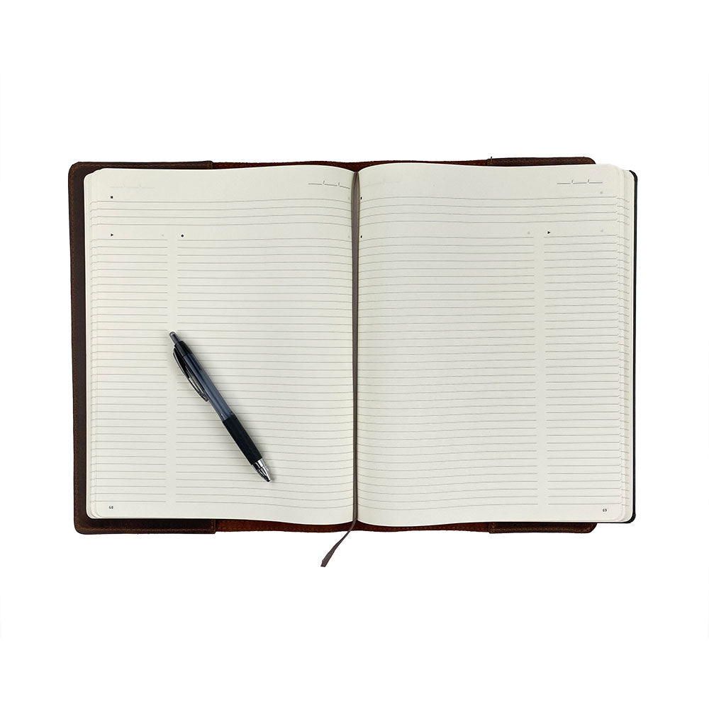 An open Hard Cover Notebook Protector (Notebook NOT Included) by Hide & Drink, displaying the premium leather alongside a pen. This journal cover fits Moleskine Hard Cover Sketchbook XXL Size (8.5 x 11 in.), Notebook NOT Included, crafted from Full Grain Leather, showcasing StockyardX's small batch production with hand cut, hand sewn, and fire branded techniques by artisans. Handmade in La Antigua Guatemala & Oaxaca Mexico.