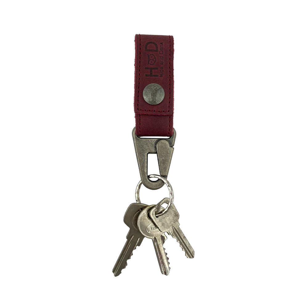 Hide & Drink Key Ring Holder elegantly holding keys, emphasizing its practical design and use of high-quality Full Grain Leather. Key Ring Holder, Full Grain Leather, StockyardX, Small Batch Production, Hand Cut, Hand Sewn, Fire Branded, Artisan, Handmade in La Antigua Guatemala & Oaxaca Mexico.