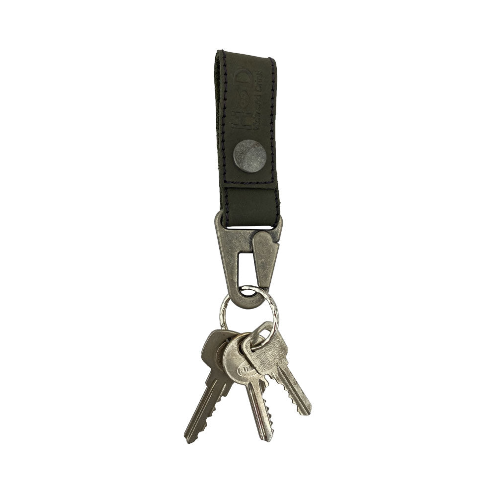 Key Ring Holder from Hide & Drink featuring keys attached to a sleek design of Full Grain Leather. This practical and stylish accessory is produced with small batch production methods, handcrafted by artisans, fire branded, and designed in La Antigua Guatemala & Oaxaca Mexico.