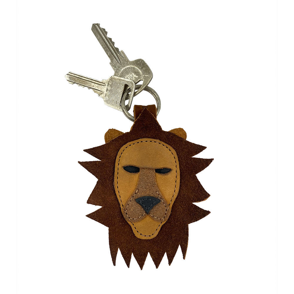 Lion Keychain by Hide & Drink holding keys, designed with attractive suede leather and detailed lion face. This unique key holder is perfect for Leo zodiac fans, showcasing craftsmanship from La Antigua Guatemala & Oaxaca Mexico and representing small batch production.