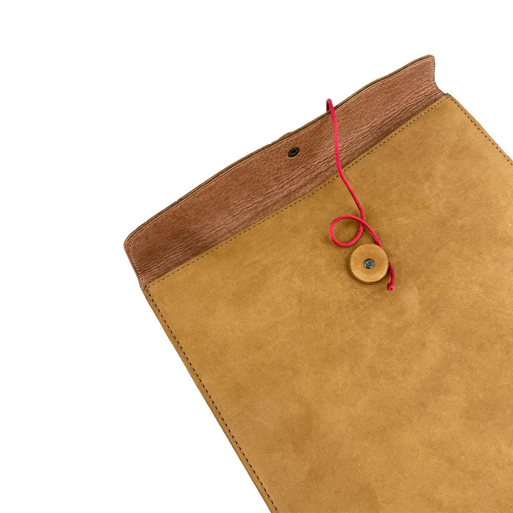 Camera angle emphasizing the detailed stitching on the Mailing Envelope Folder by Hide & Drink. This durable Mailing Envelope Document Holder made from Full Grain Leather is perfect for keeping documents safe while offering an elegant accessory for any office setting.
