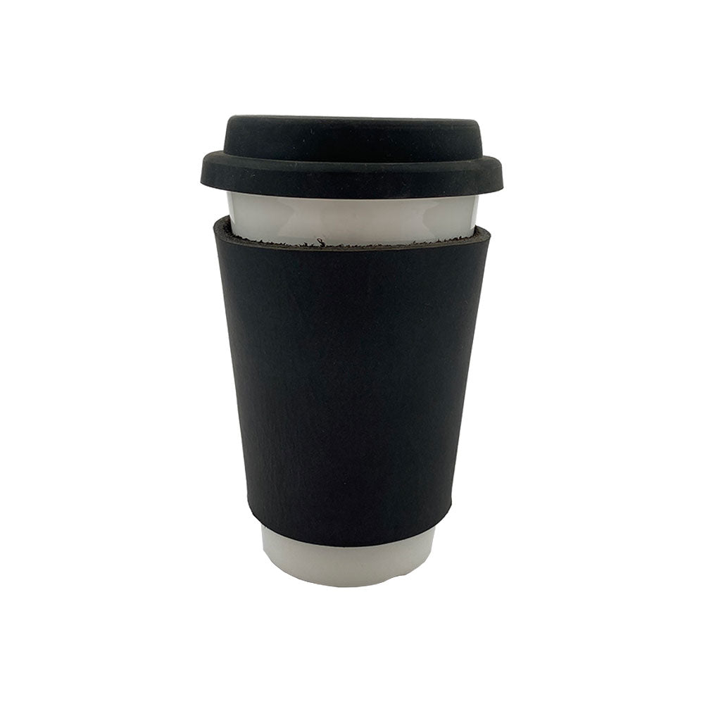 The black leather Pint Sleeve designed by Hide & Drink fits snugly over a coffee cup, combining functionality with classic style. Offering natural insulation, it features brass metal rivets and is part of small batch artisan production from La Antigua Guatemala & Oaxaca Mexico.